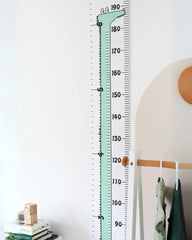 a child's growth chart hanging on a wall