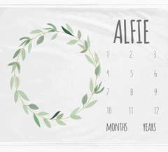 a calendar with a wreath of leaves on it