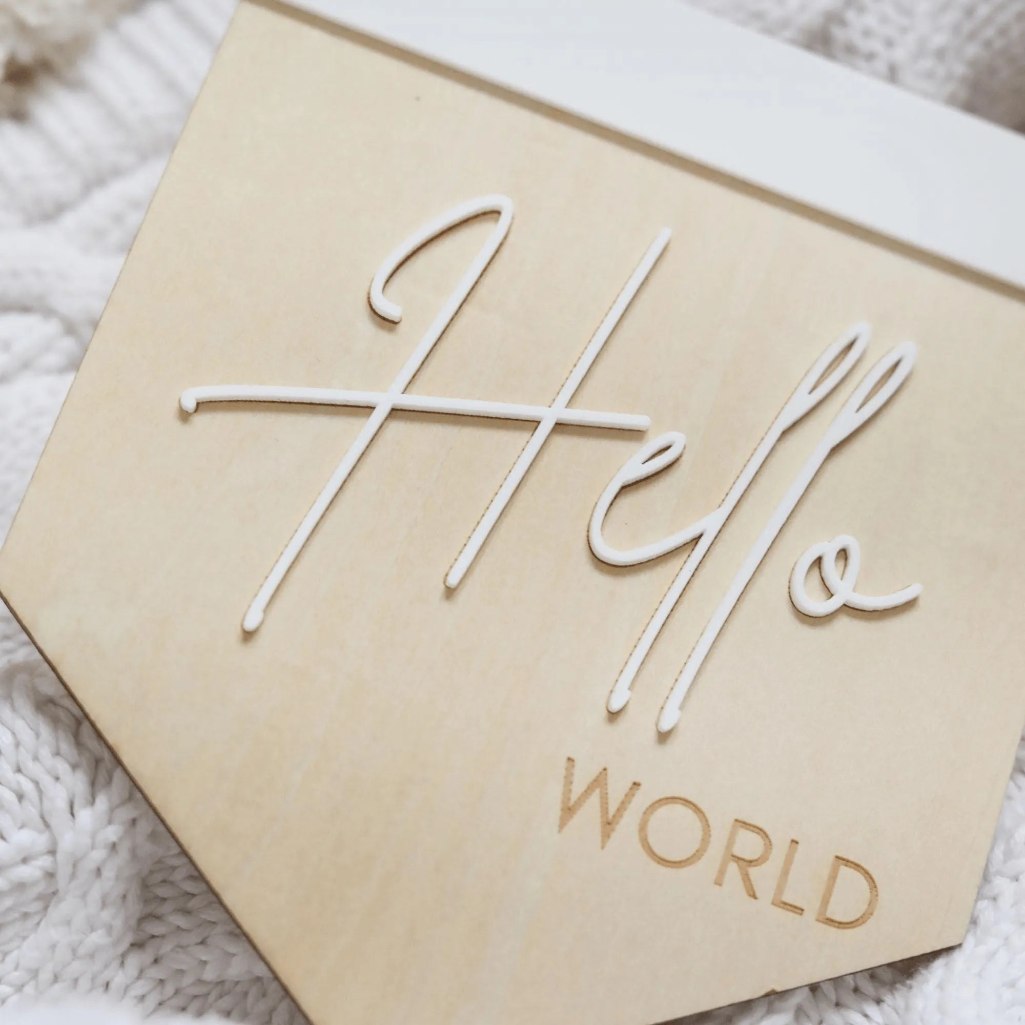 a wooden sign that says hello world on it