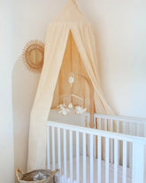 a white crib in a white room with a white wall