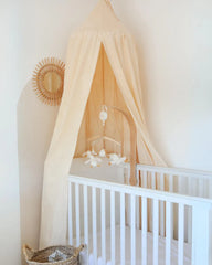 a white crib in a white room with a white wall