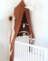 a white crib with a brown canopy and a white crib with a brown