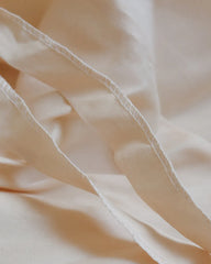 a close up of a white bed sheet