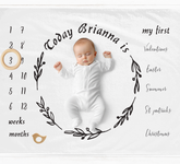 a baby is laying down on a white blanket