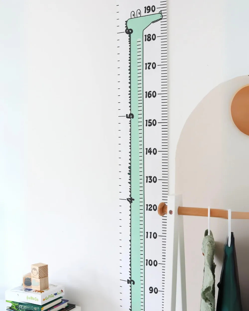 a child's room with a large growth chart on the wall