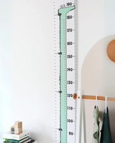 a child's room with a large growth chart on the wall