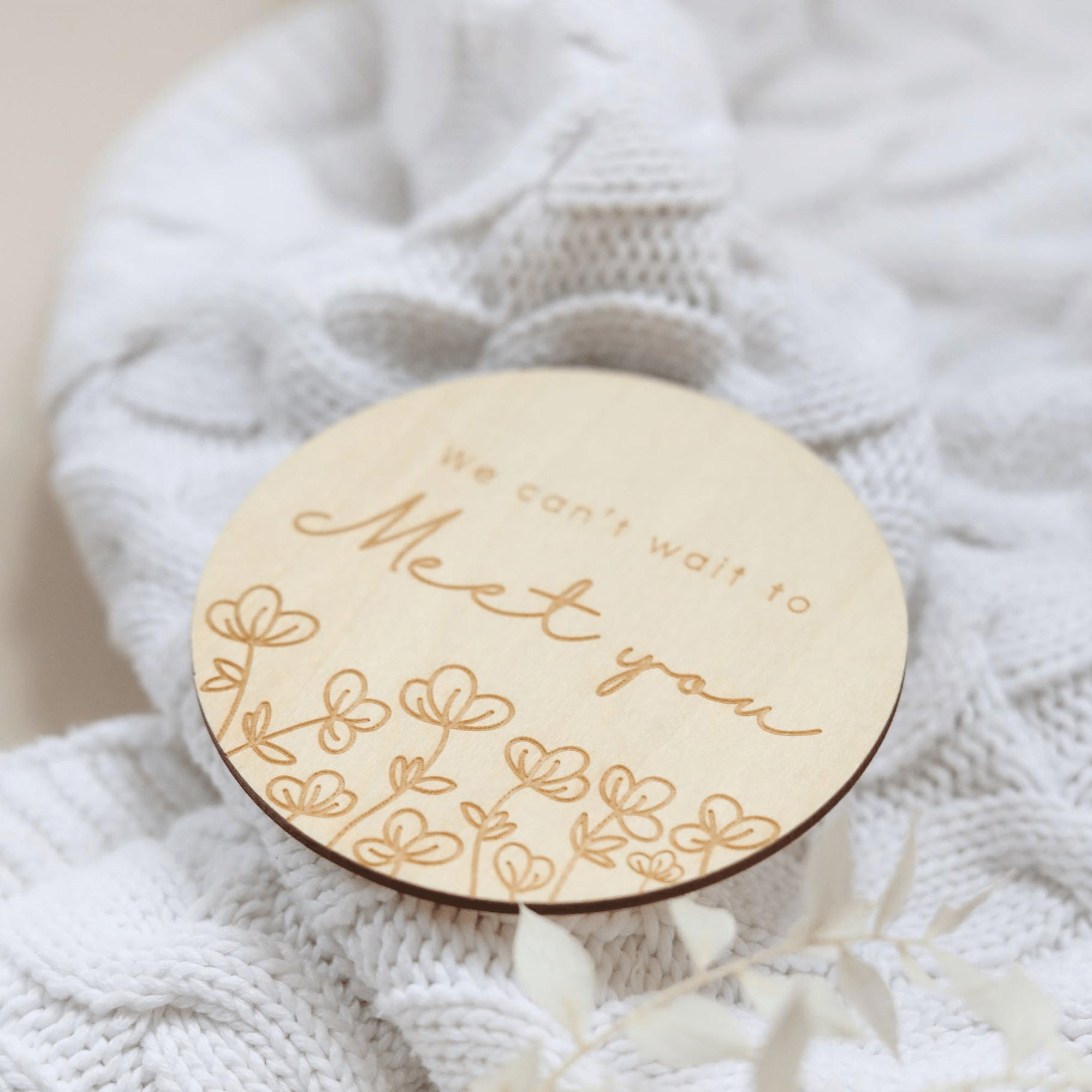 a close up of a wooden brooch with a name on it