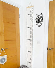 a room with a wooden door and a ruler on the wall