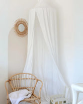 a white room with a chair and a mirror