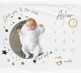 a baby is sleeping on the moon on a blanket