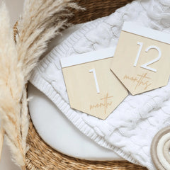 a basket with two tags on it next to a pair of scissors