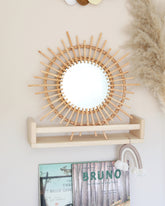 a white wall with a mirror and a shelf