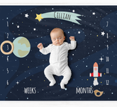 a baby in a space suit laying on the ground