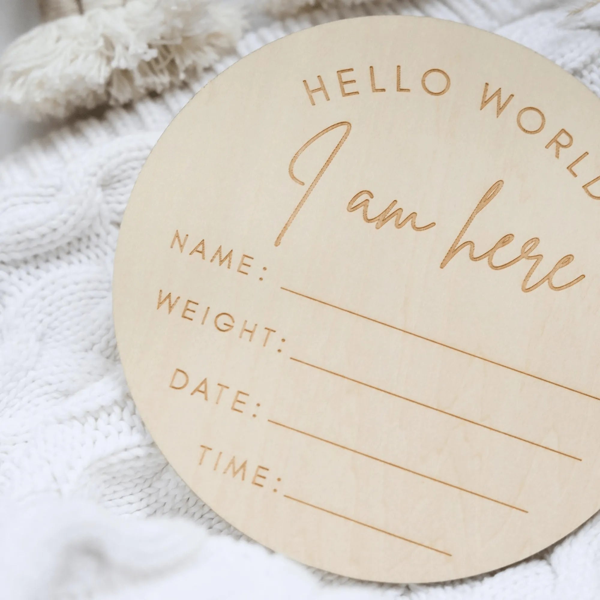 a wooden circle with a name and date on it