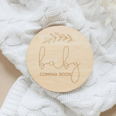 a wooden ornament that says baby coming soon