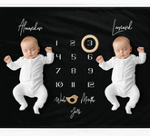 a couple of babies laying next to each other