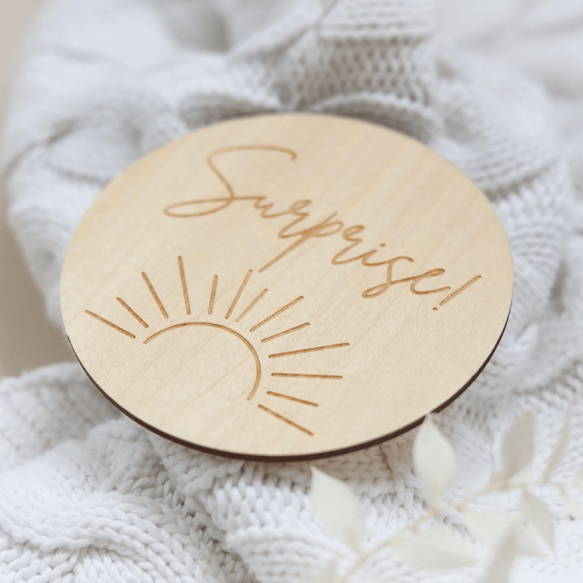 a wooden brooch with a message on it