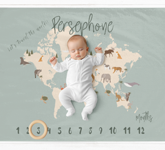 a baby is laying on a map of the world