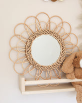 a wooden shelf with a mirror and a teddy bear
