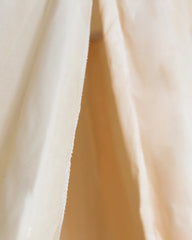 a close up of a white curtain with a white background