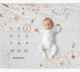 Wildflower milestone blanket with a baby girl