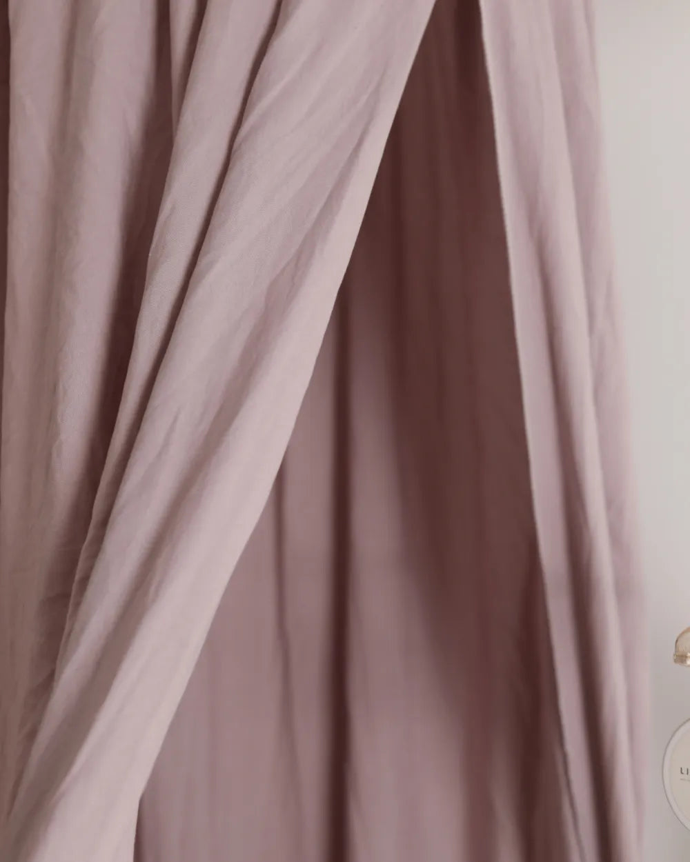 a close up of a curtain with a clock on it
