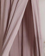 a close up of a curtain with a clock on it