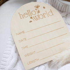 a wooden name tag attached to a white sweater