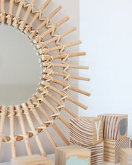 a round mirror sitting on top of a table