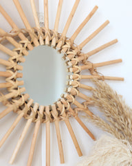 a round mirror sitting on top of a white wall