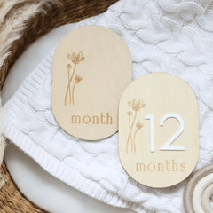 a couple of wooden tags sitting on top of a table