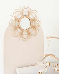 a baby crib with a crib and a mirror on the wall
