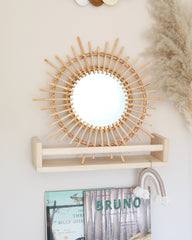 a white wall with a mirror and a shelf