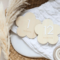 a basket filled with wooden cutouts of clouds