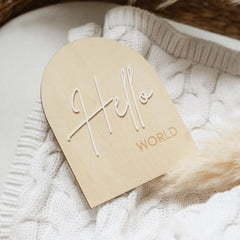 a wooden name tag on a white sweater