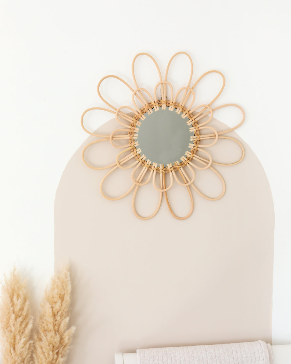 a mirror on a wall next to a plant