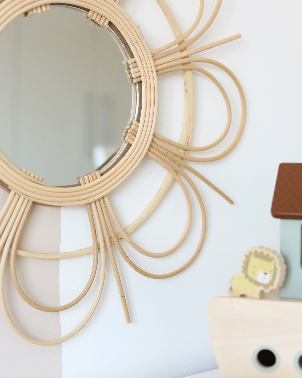 a mirror that is on a wall near a toy