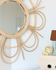 a mirror that is on a wall near a toy
