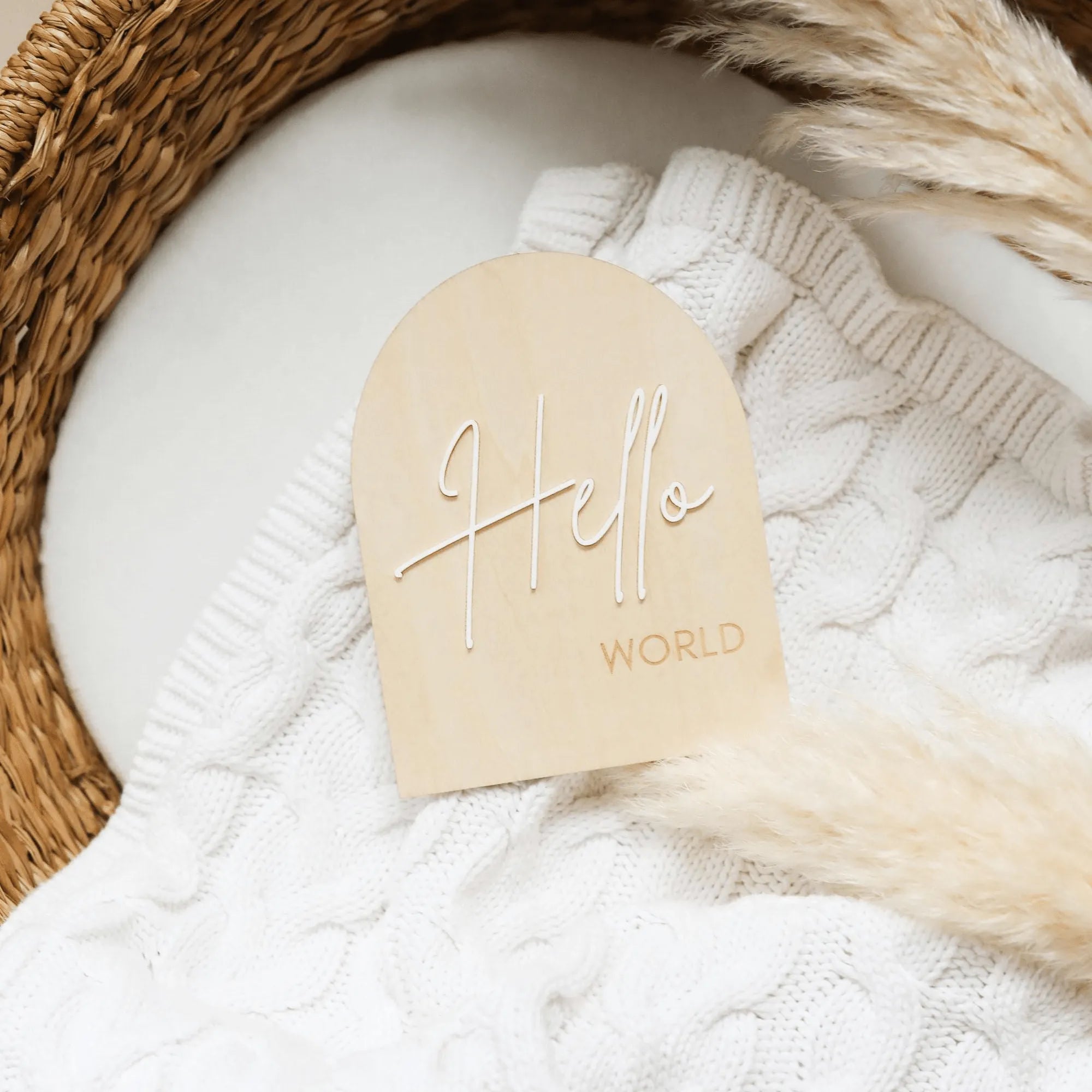 a white sweater with a wooden name tag on it