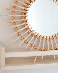 a mirror that is sitting on a shelf