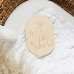 a close up of a wooden tag on a blanket
