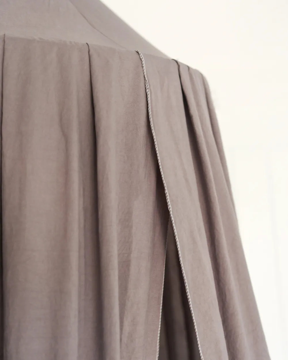 a close up of a person wearing a gray shirt